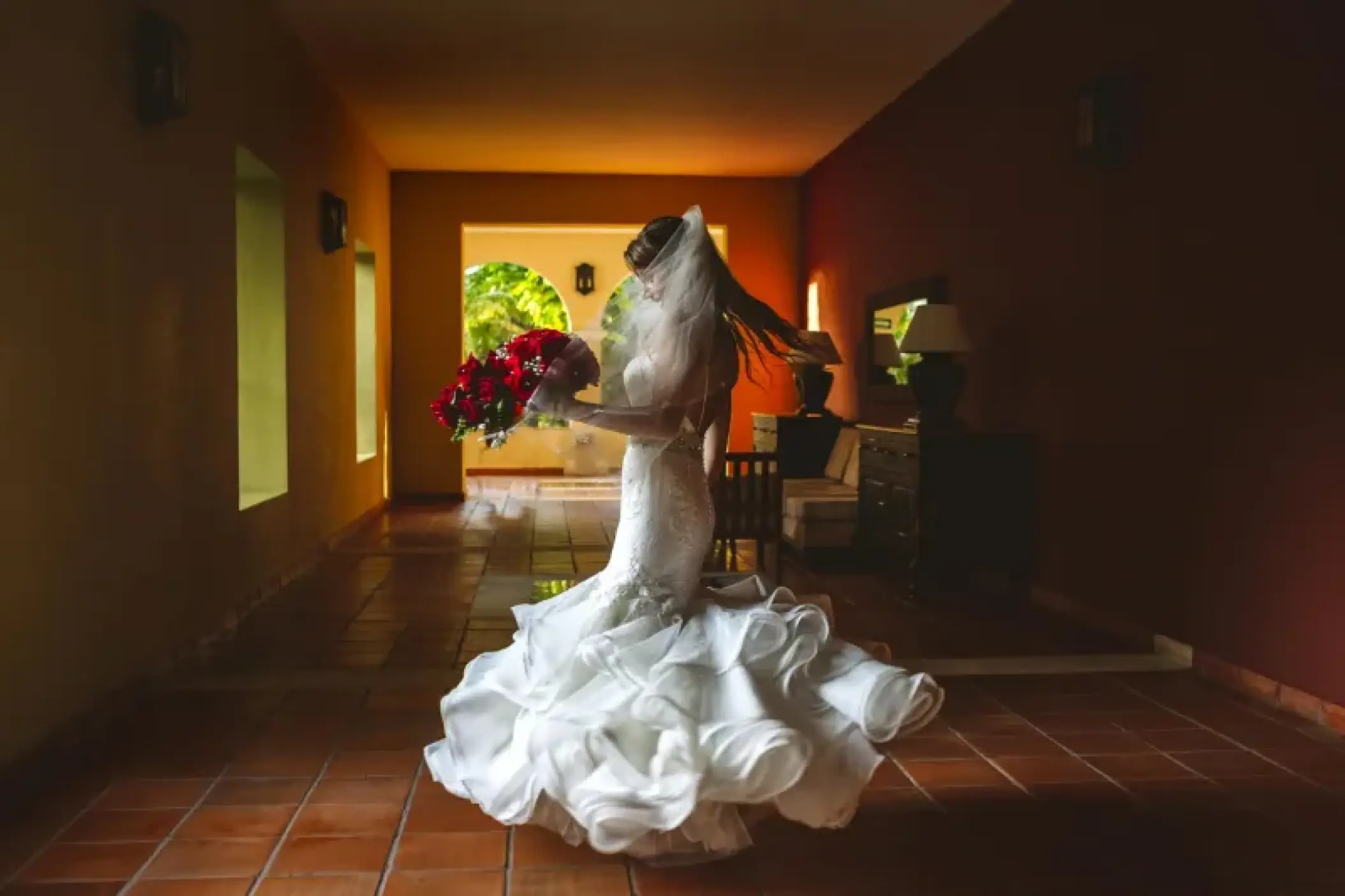 Bride twirling in her wedding dress in the foyer at Valentin Imperial, Riviera Maya
