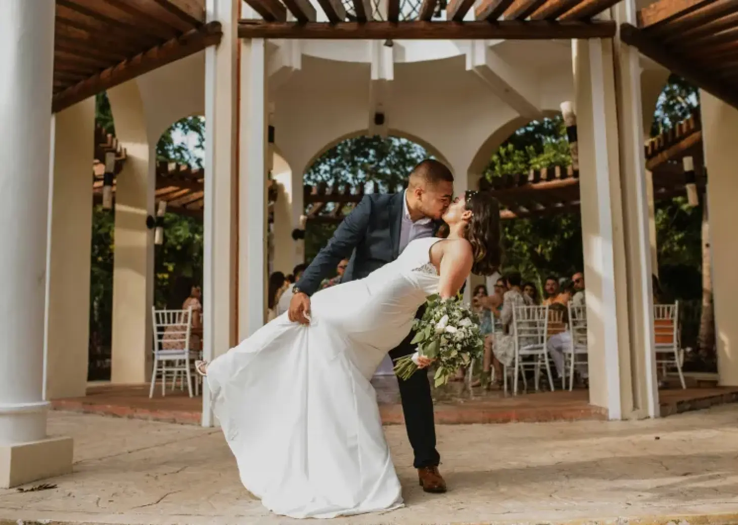The bride and groom kissing in the wedding gazebo at Valentin Imperial, Riviera Maya