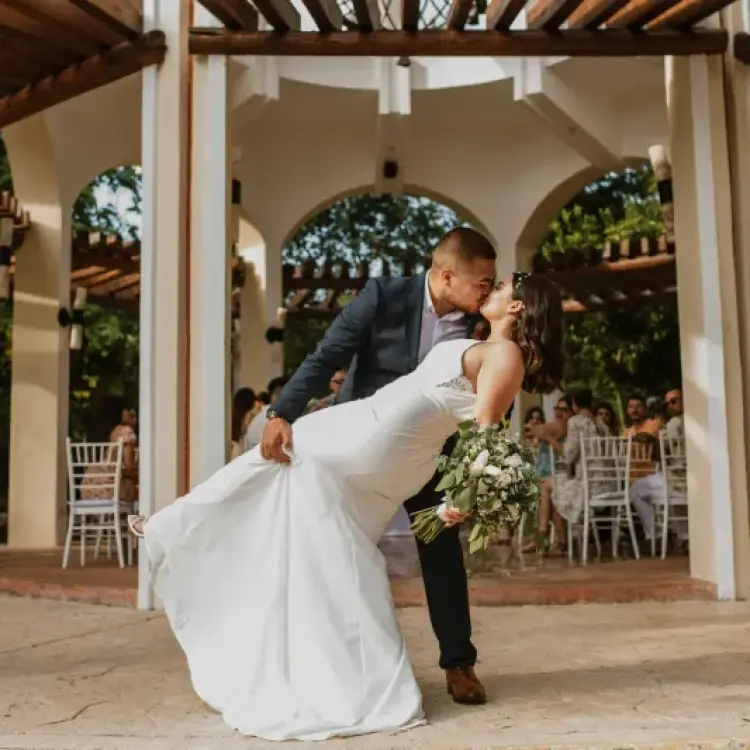 The bride and groom kissing in the wedding gazebo at Valentin Imperial, Riviera Maya