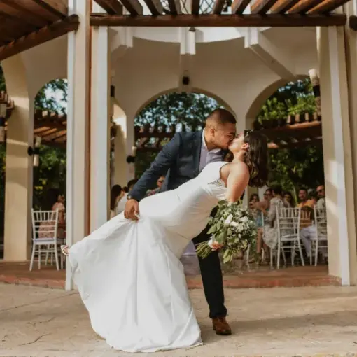 The bride and groom kissing in the wedding gazebo at Valentin Imperial, Riviera Maya
