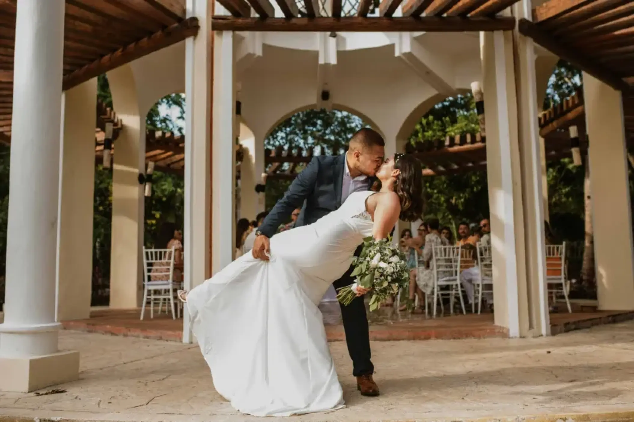 The bride and groom kissing in the wedding gazebo at Valentin Imperial, Riviera Maya