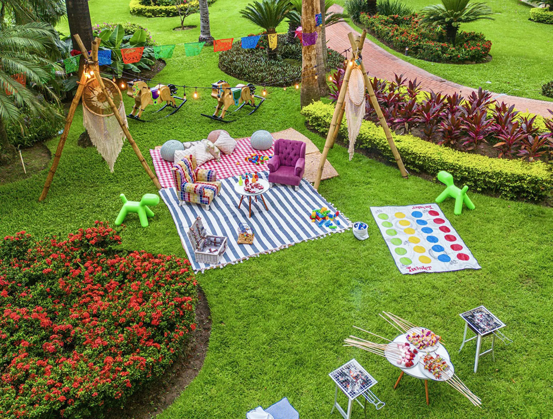 Colorful family picnic setup with teepees and games on the lawn at Velas Vallarta, Puerto Vallarta