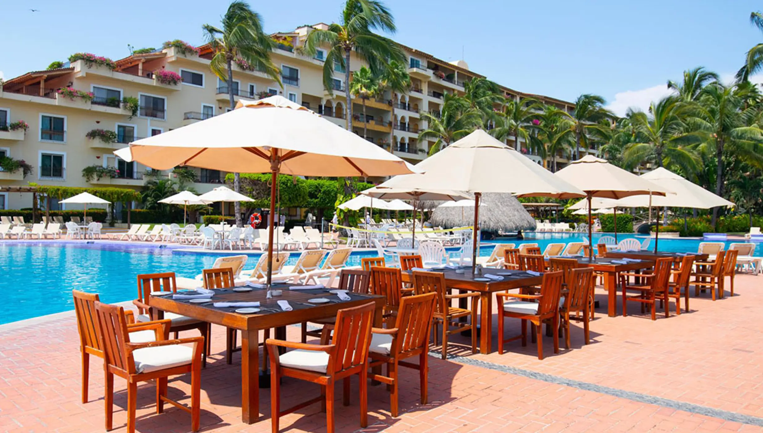 La Rivera restaurant terrace with outdoor tables and umbrellas at Velas Vallarta, Puerto Vallarta
