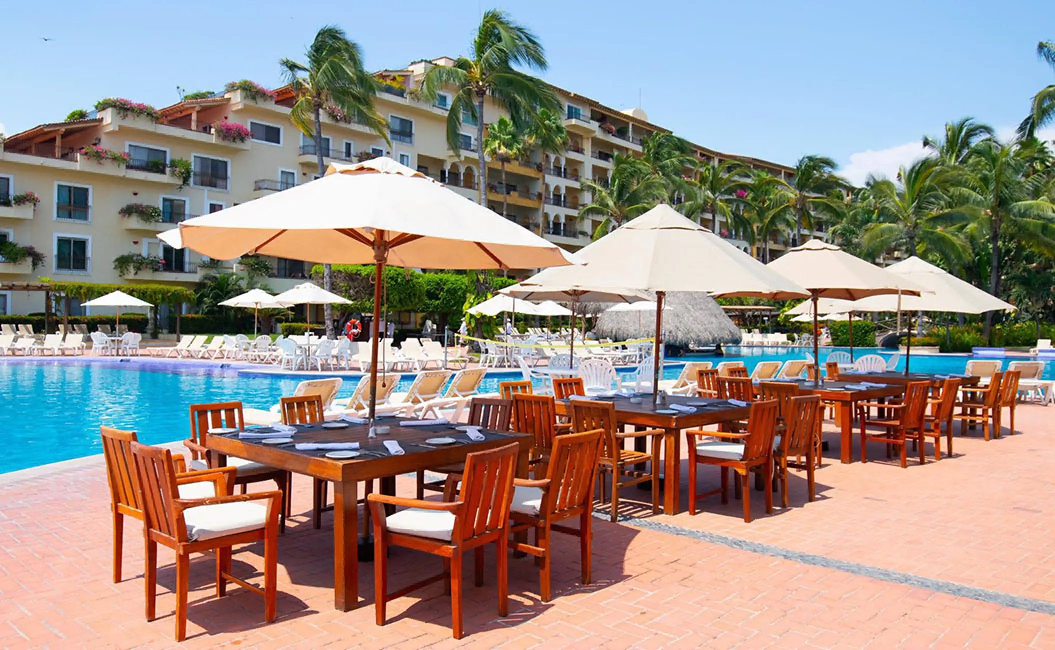 La Rivera restaurant terrace with outdoor tables and umbrellas at Velas Vallarta, Puerto Vallarta