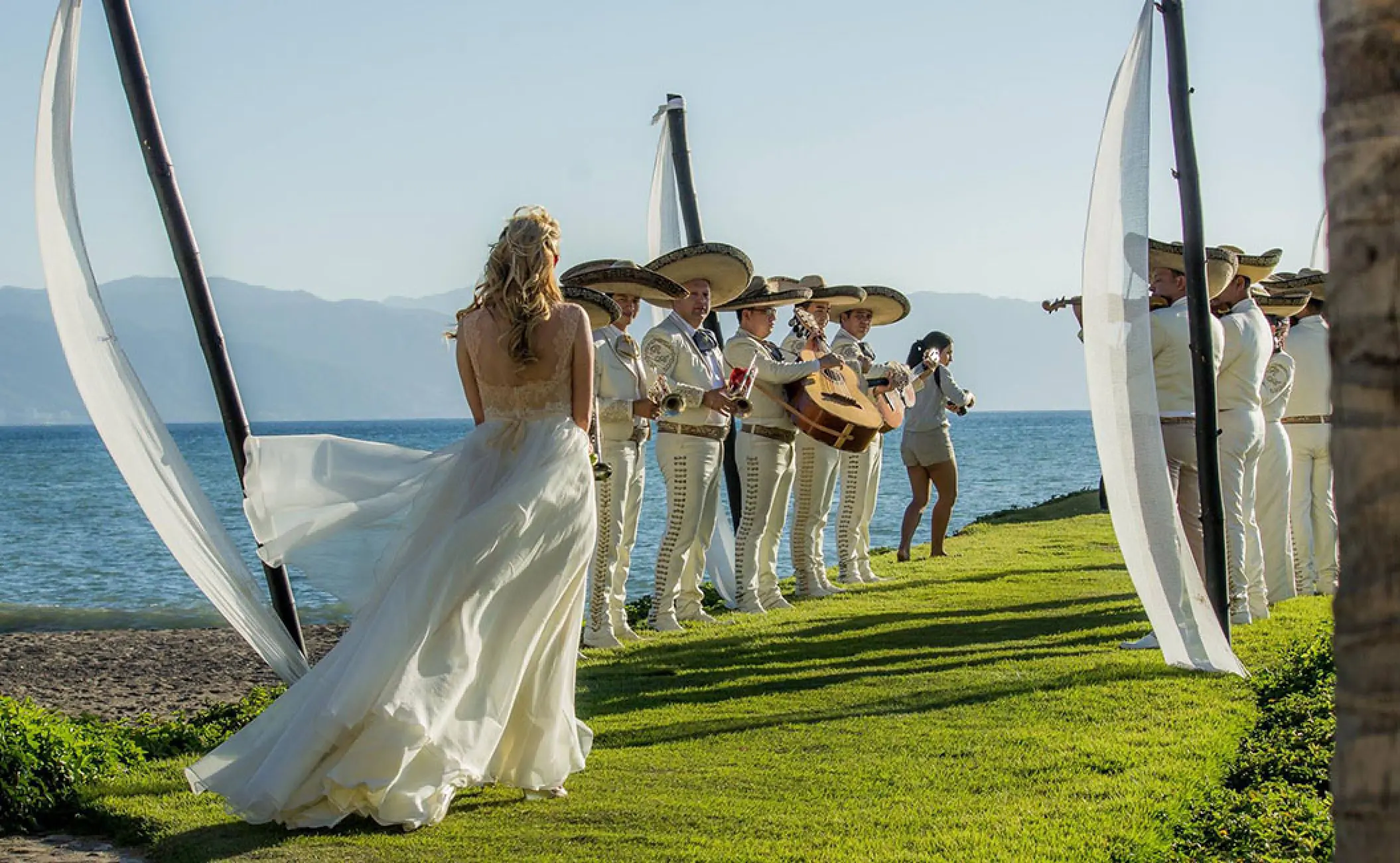 Bride walking down the aisle towards a mariachi band at Velas Vallarta, Puerto Vallarta