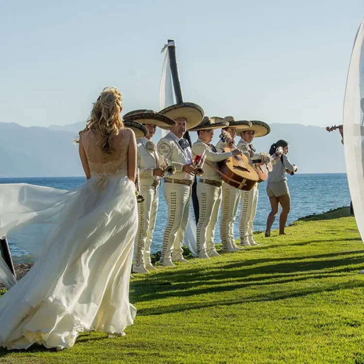 Bride walking down the aisle towards a mariachi band at Velas Vallarta, Puerto Vallarta
