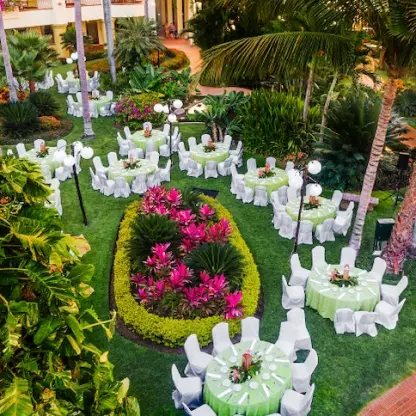 Garden wedding reception at Velas Vallarta with round tables set on a lush green lawn in Puerto Vallarta