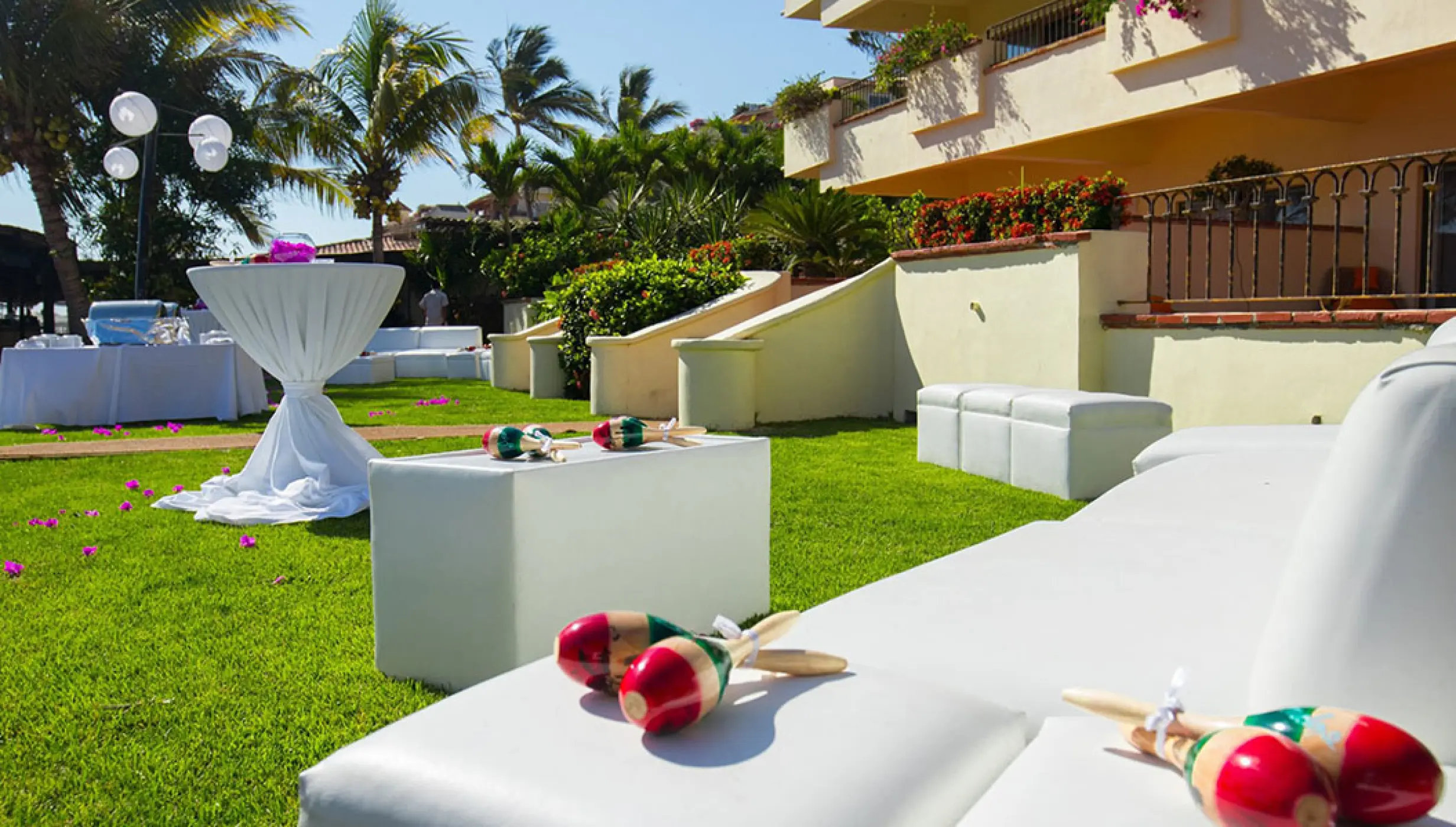 Garden wedding reception lounge with white sofas and maracas at Velas Vallarta, Puerto Vallarta