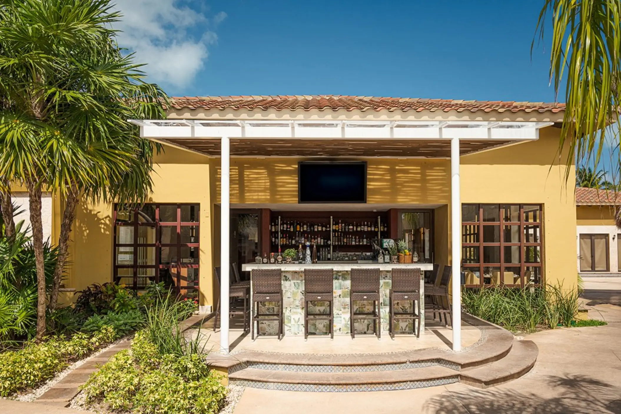 La Casona outdoor bar with wicker seating at Villa del Palmar Cancun