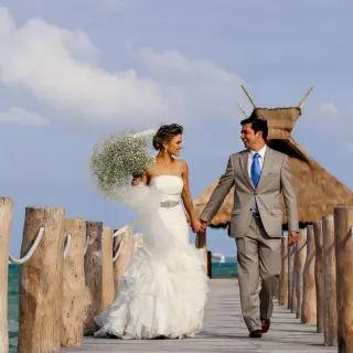 The bride and groom walking on the pier at Villa del Palmar, Cancun