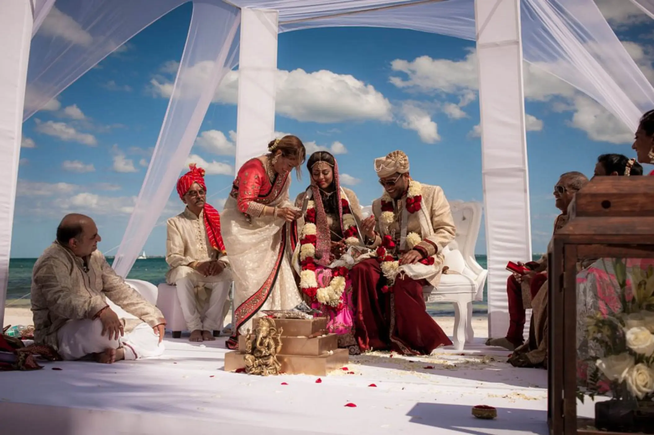 Traditional Indian wedding ceremony under a white draped mandap at Villa del Palmar, Cancun
