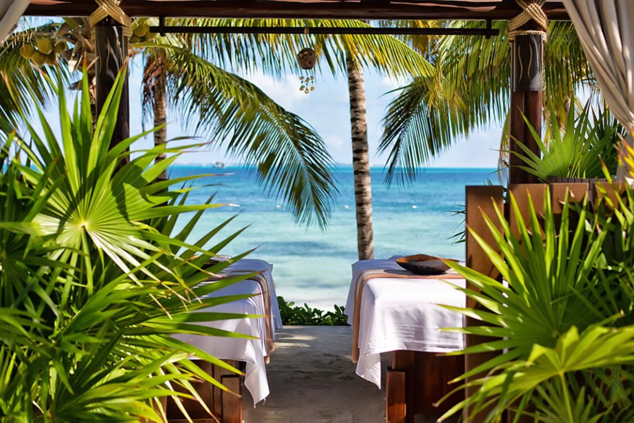 Oceanfront spa massage tables under a gazebo at Villa del Palmar Cancun