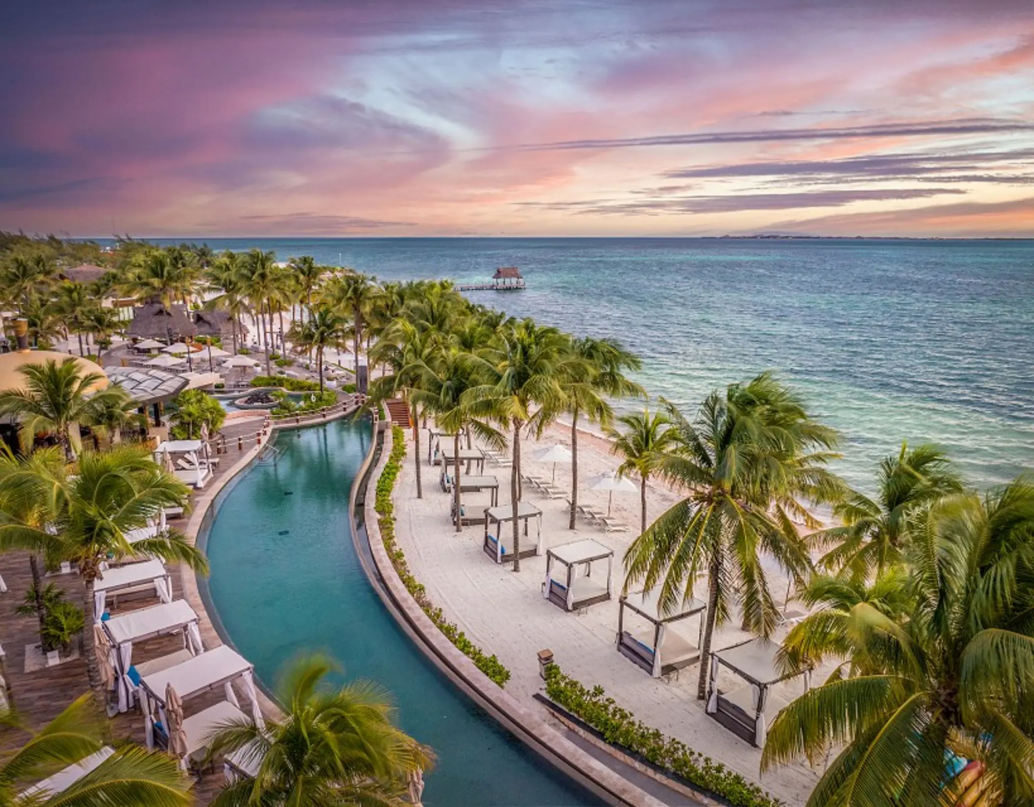 Oceanfront pool and beach cabanas at Villa del Palmar, Cancun
