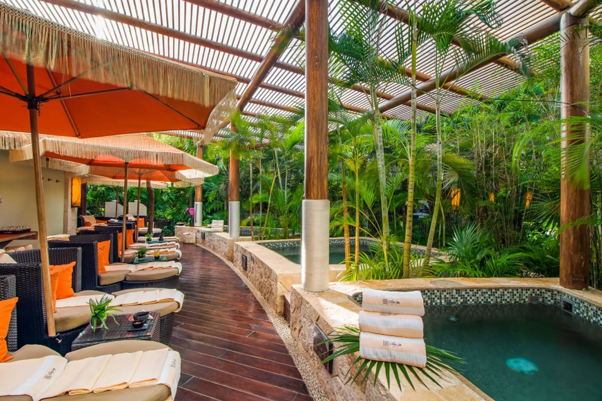 Village Spa relaxation area with hot tubs and lounge chairs at Villa del Palmar, Cancun