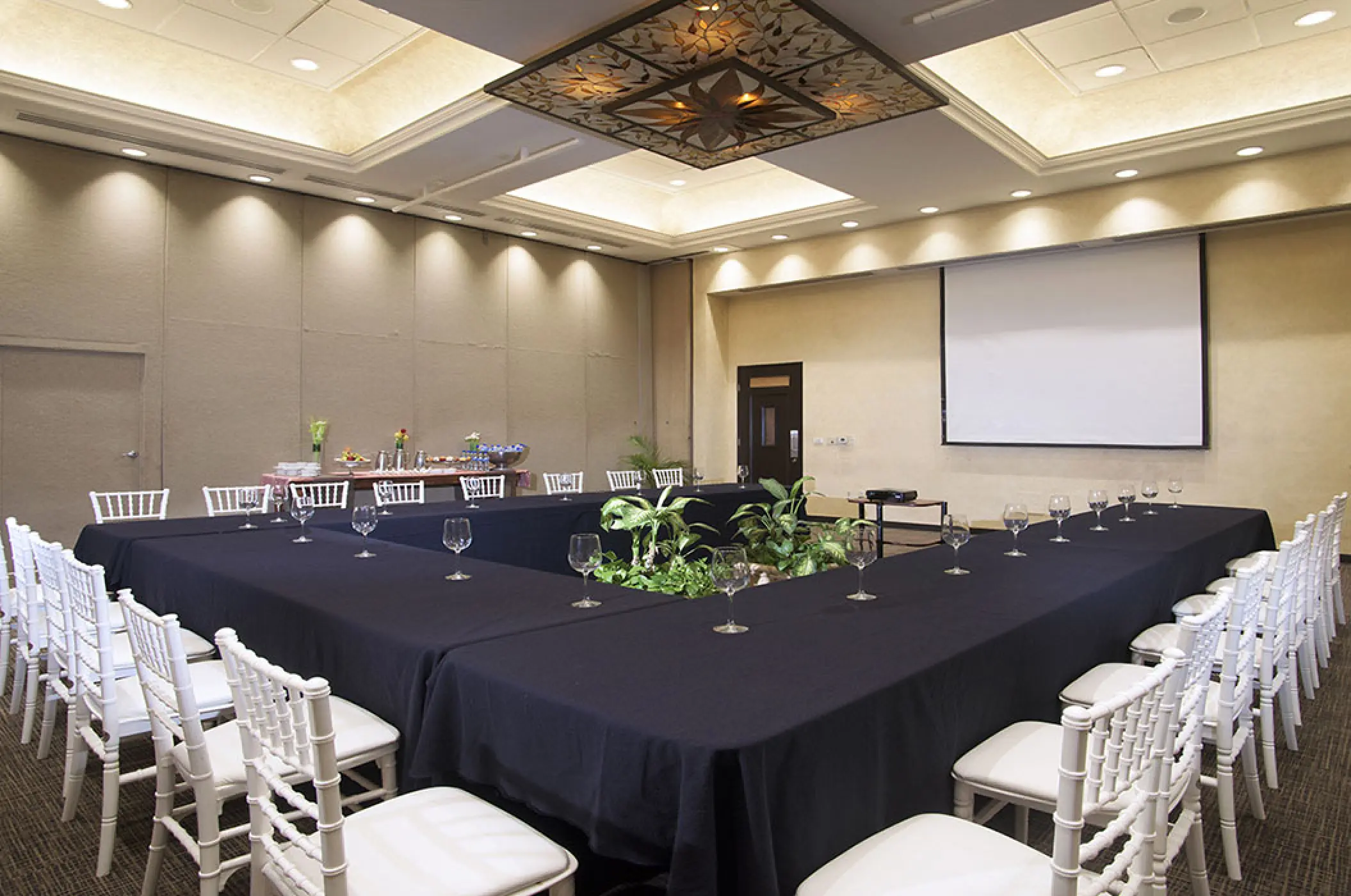 U-shaped conference table and white chairs in the ballroom at Villa La Estancia, Puerto Vallarta
