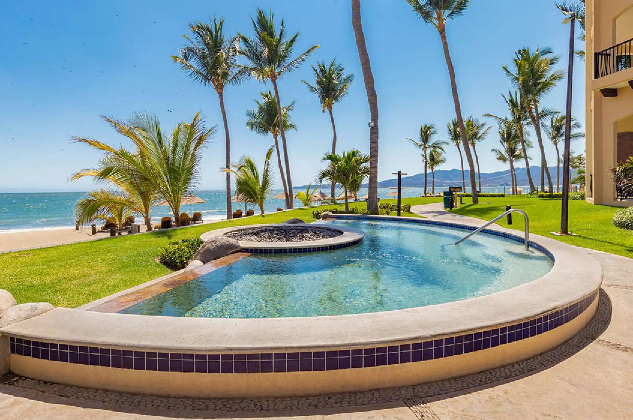 Outdoor hot tub overlooking the beach and palm trees at Villa La Estancia Riviera Nayarit, Puerto Vallarta