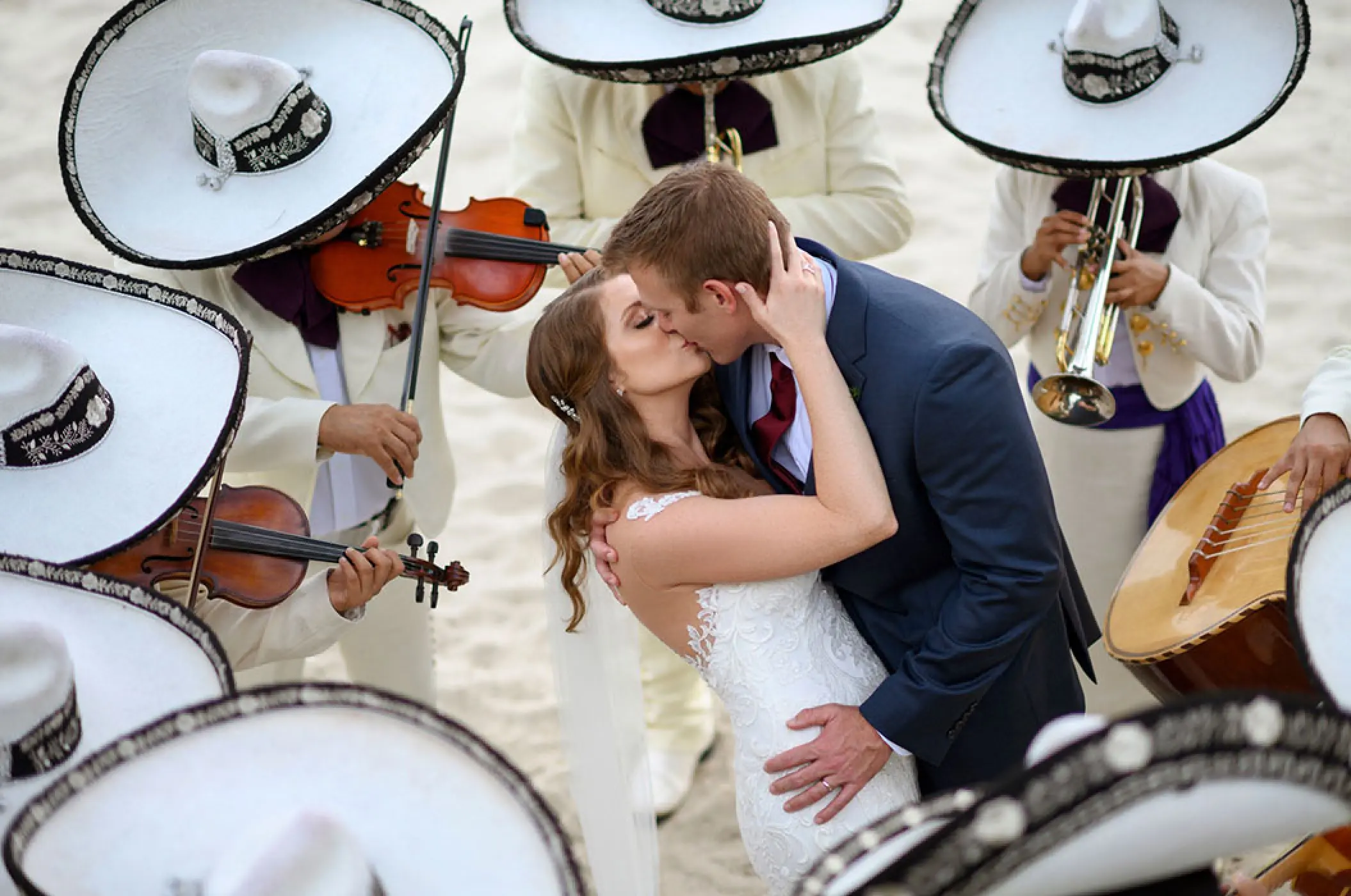 The couple kissing surrounded by a mariachi band at Villa La Estancia, Puerto Vallarta