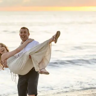 Groom carrying his bride on the beach at sunset, Villa La Estancia Riviera Nayarit