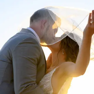 Bride and groom kissing under a veil at Villa La Estancia Riviera Nayarit, Puerto Vallarta