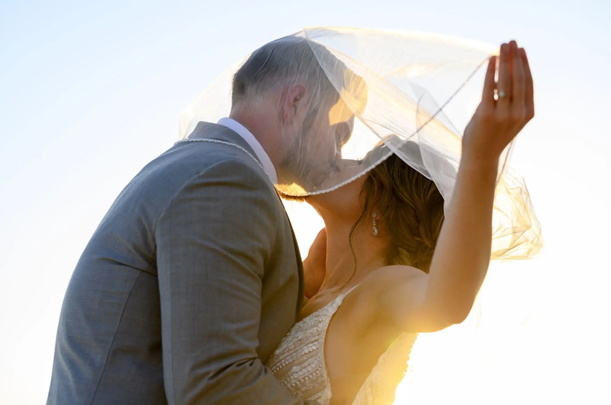Bride and groom kissing under a veil at Villa La Estancia Riviera Nayarit, Puerto Vallarta