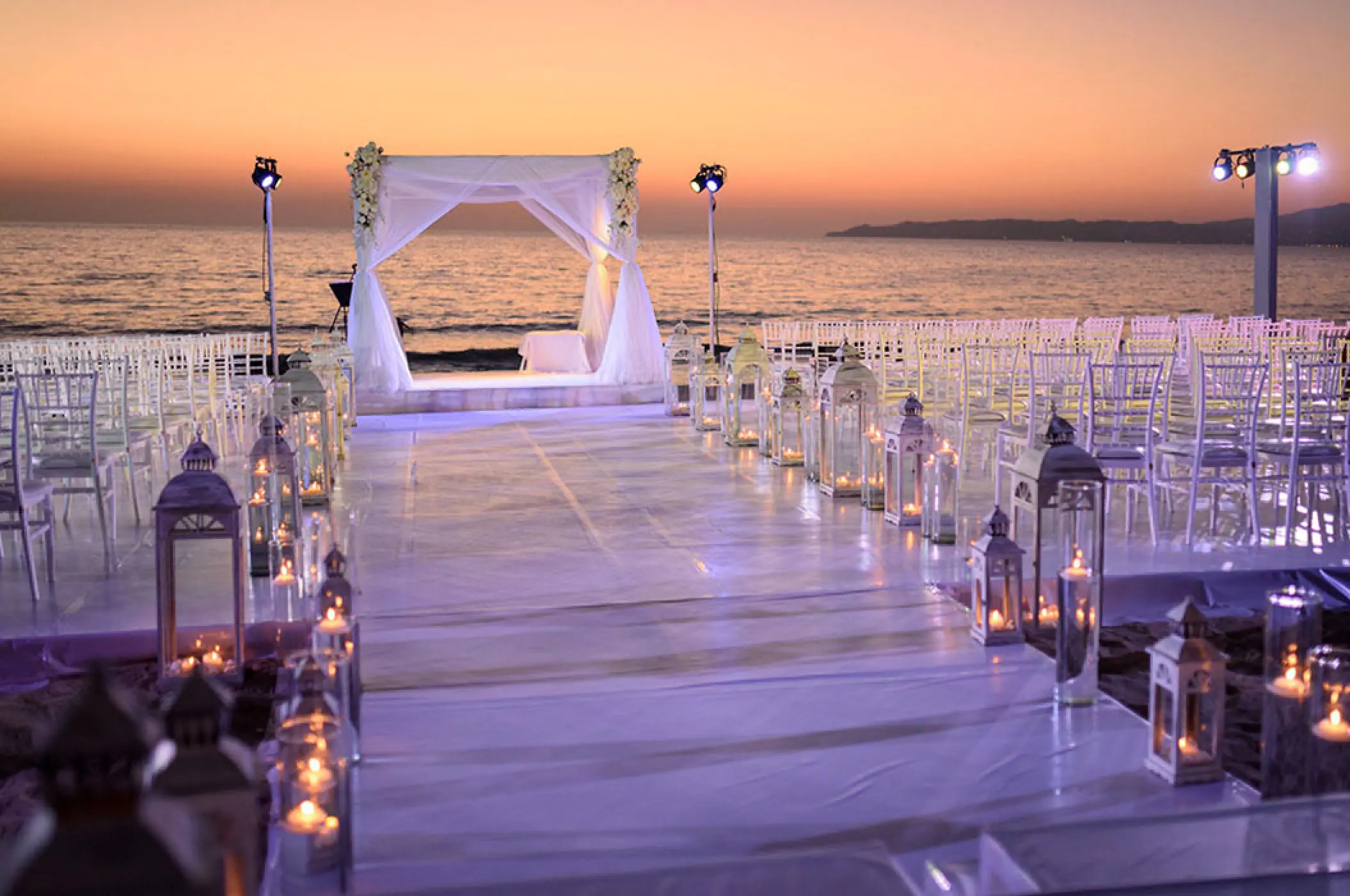 Beachfront wedding ceremony with lanterns and sunset views at Villa La Estancia Riviera Nayarit, Puerto Vallarta