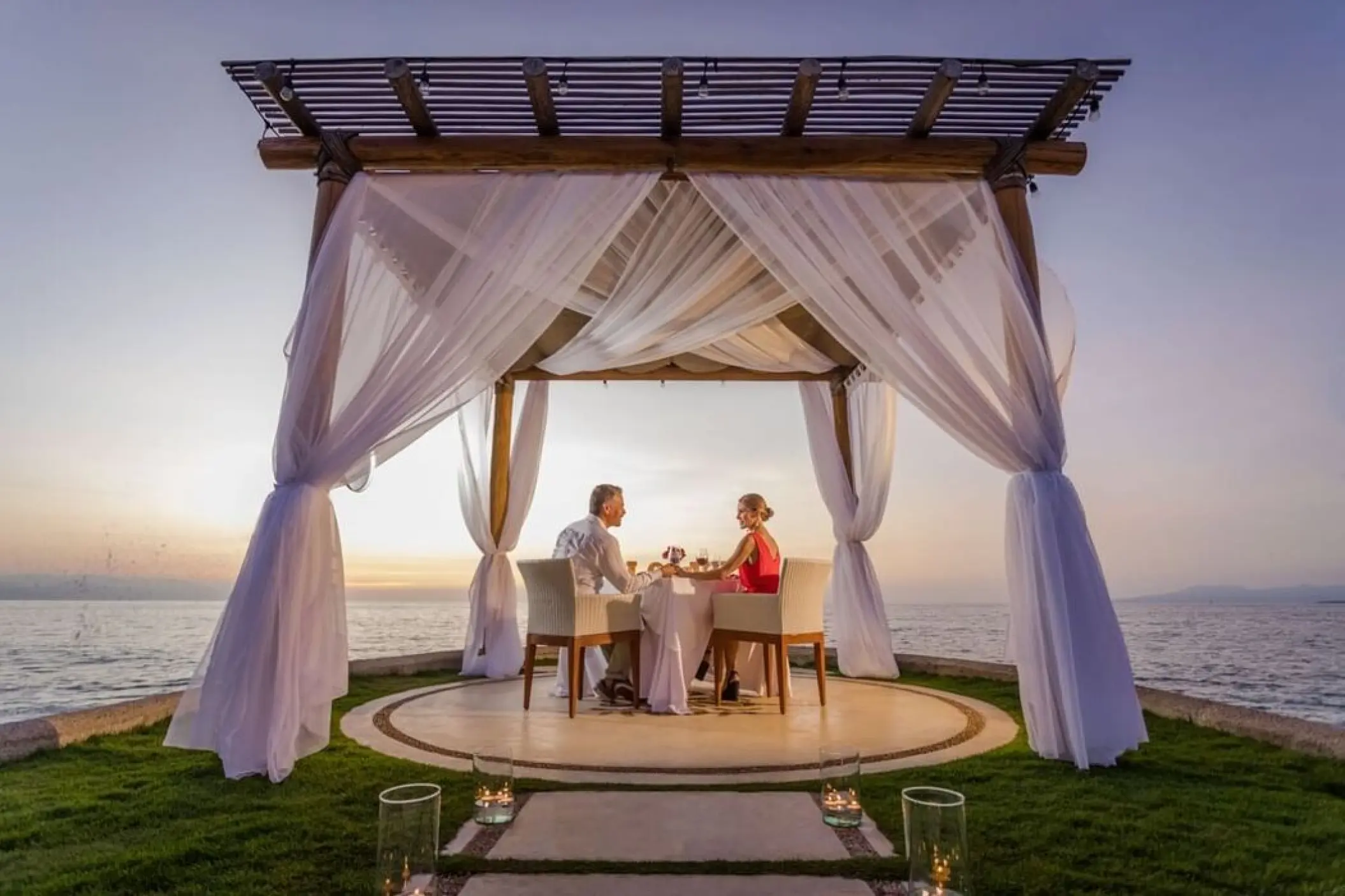 Sunset romantic dinner under a white draped cabana at Villa Premiere Boutique Hotel, Puerto Vallarta