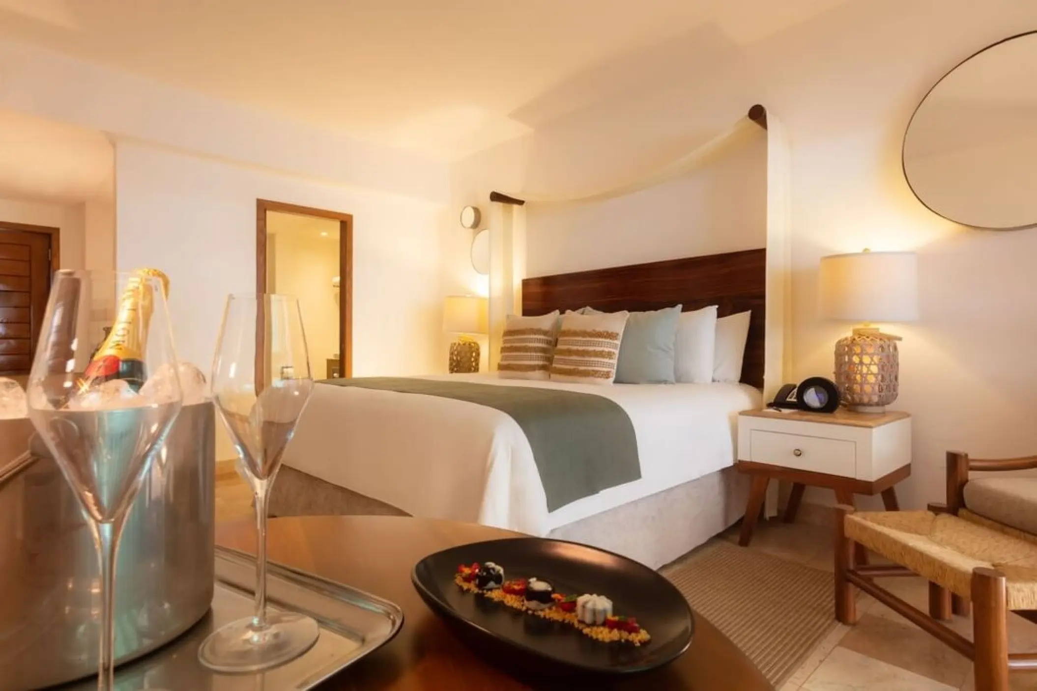 Guest suite at Villa Premiere Boutique Hotel with champagne and snacks in the foreground, Puerto Vallarta