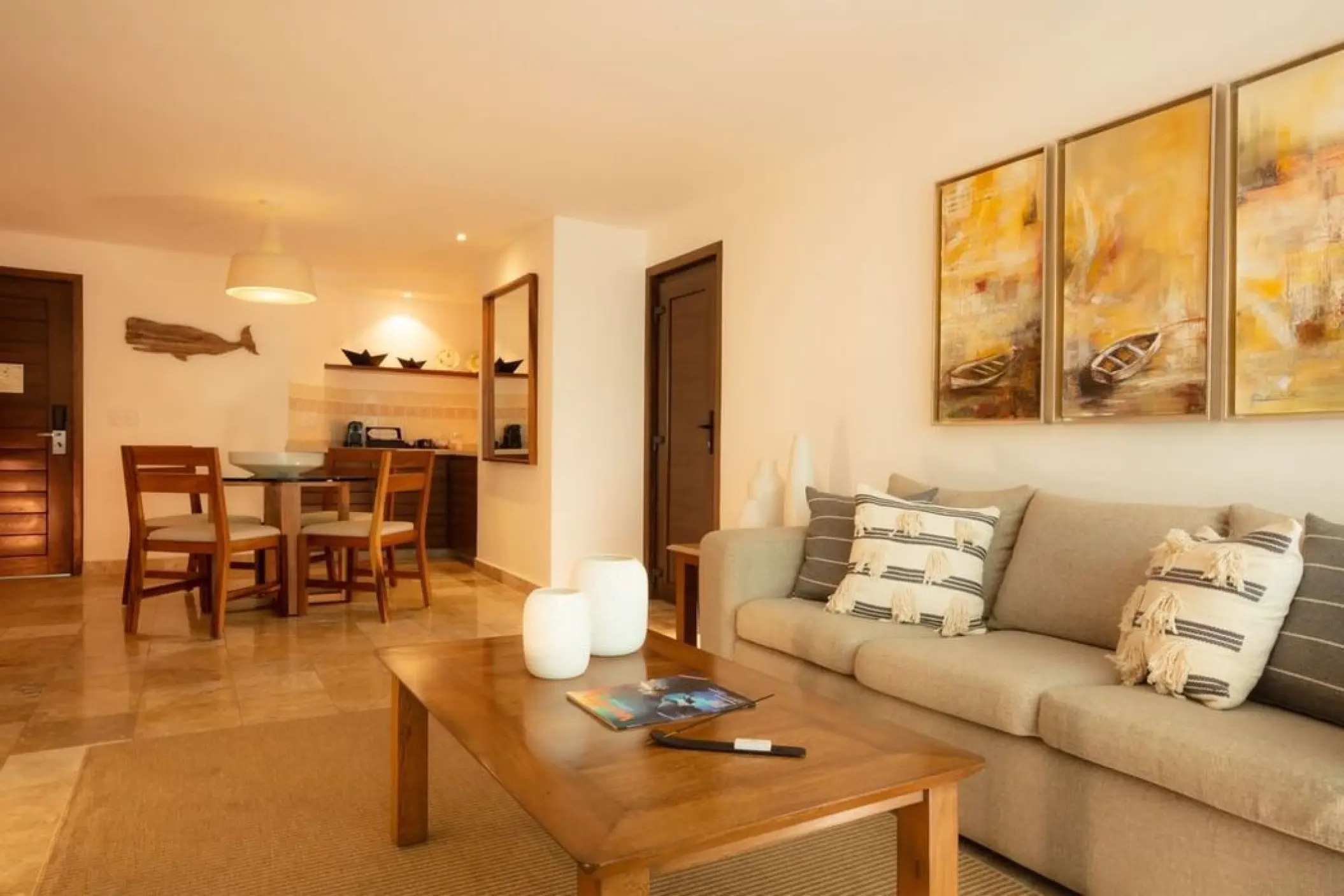 Modern guest suite living area with sofa and dining table at Villa Premiere Boutique Hotel, Puerto Vallarta