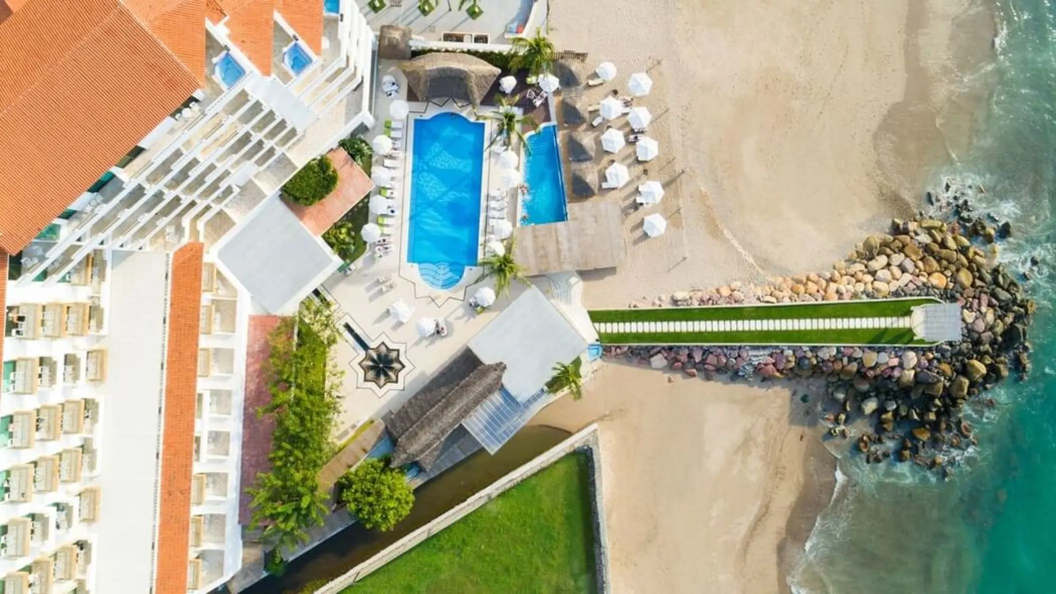 Aerial view of the pools and beachfront at Villa Premiere Boutique Hotel, Puerto Vallarta