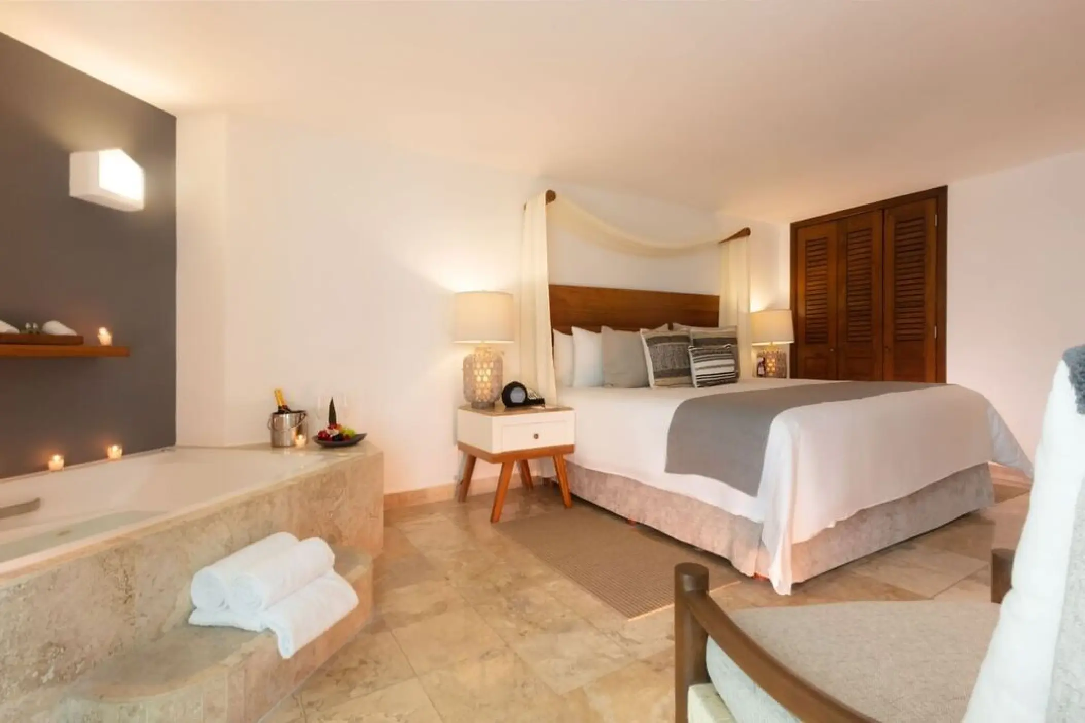 Soaking tub and canopy bed in a guest suite at Villa Premiere Boutique Hotel, Puerto Vallarta