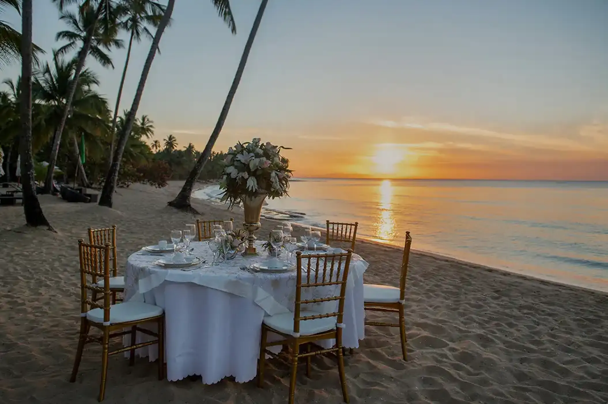 Private wedding reception table on the beach at sunset at Viva Maya by Wyndham, Playa Del Carmen