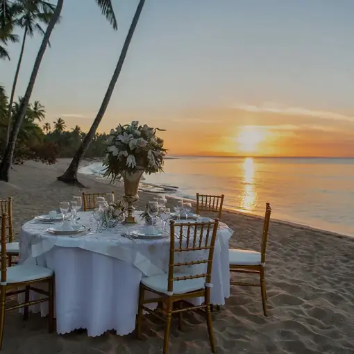 Private wedding reception table on the beach at sunset at Viva Maya by Wyndham, Playa Del Carmen
