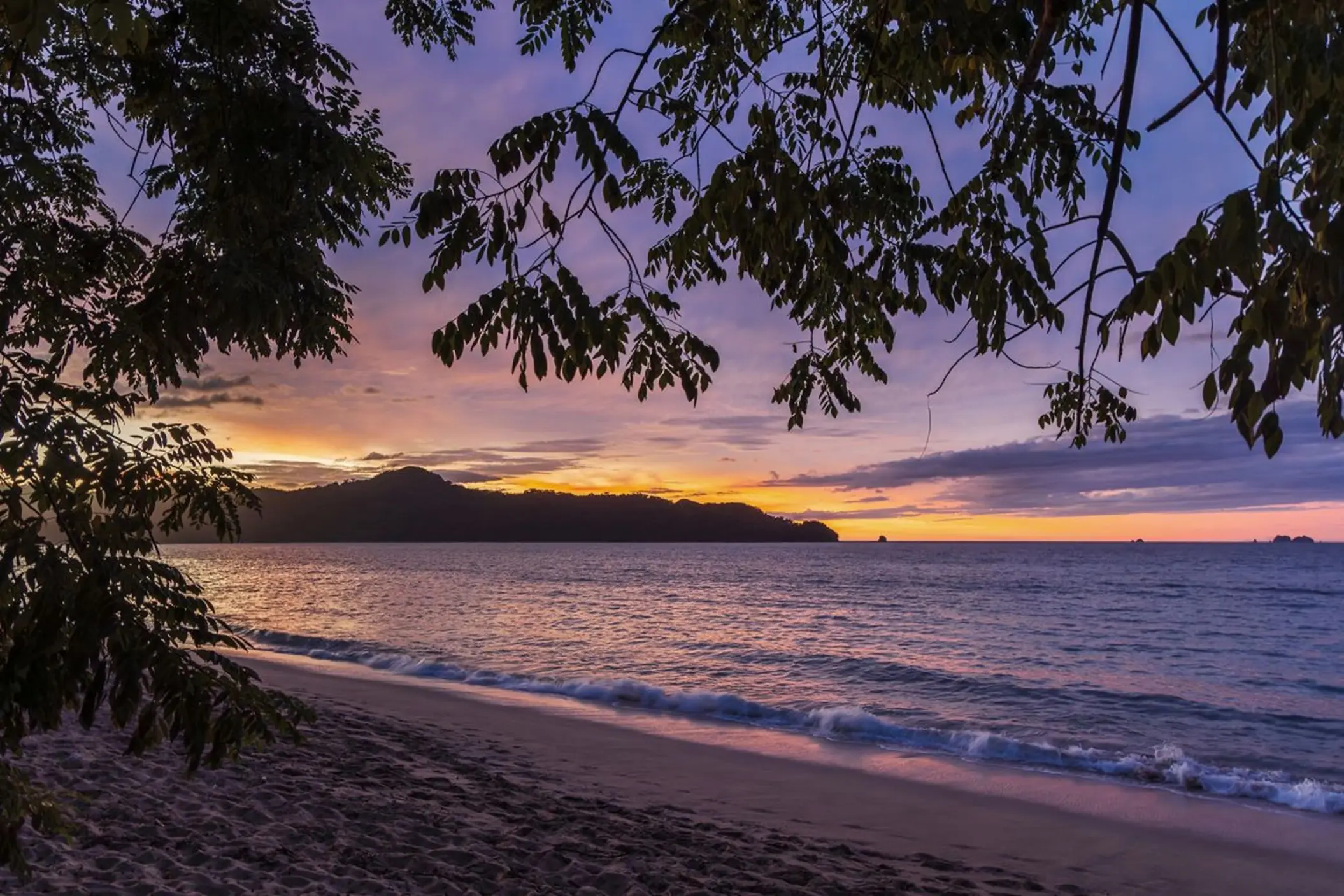 Purple and orange sunset over the beach at The Westin Reserva Conchal, Liberia