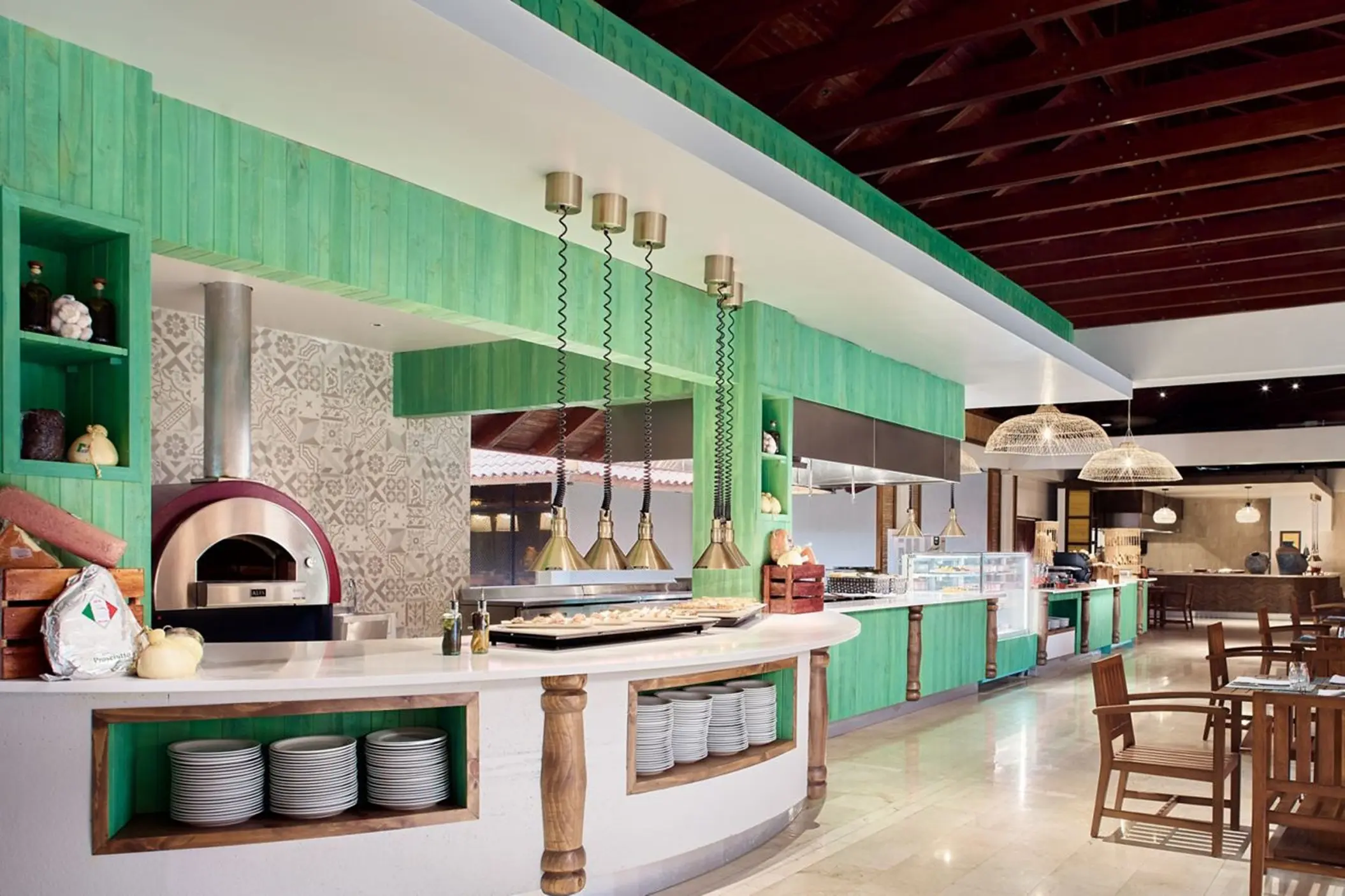 Buffet restaurant with a pizza oven and green wood paneling at The Westin Reserva Conchal, Liberia