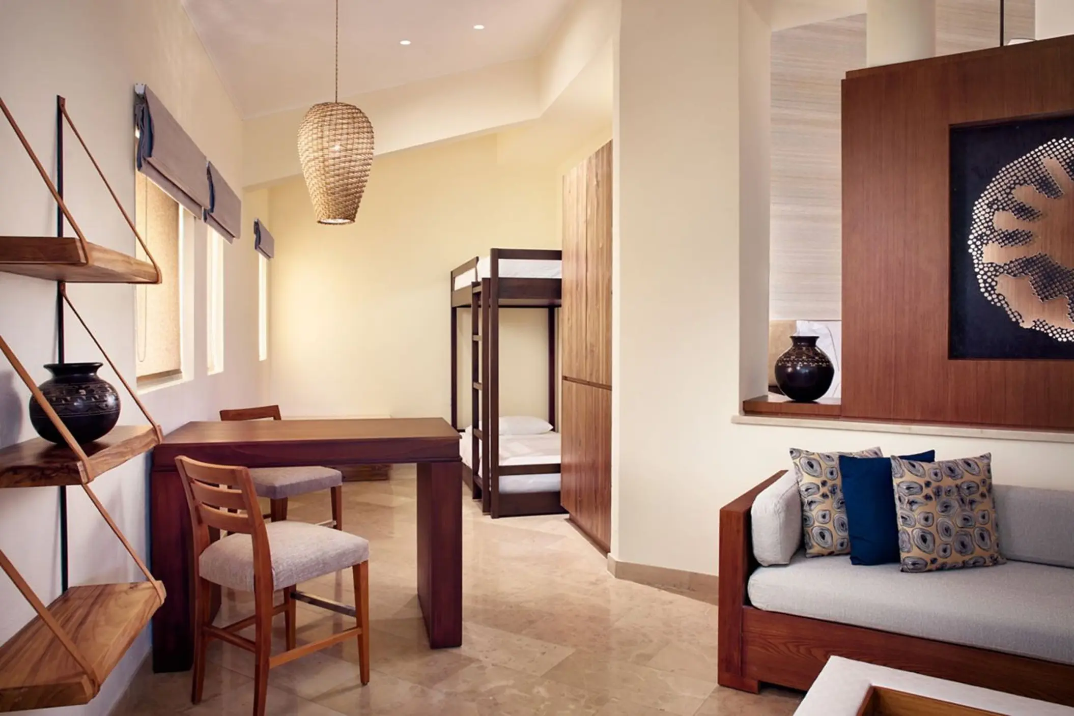 Family suite with a bunk bed, dining table and sofa at The Westin Reserva Conchal, Liberia