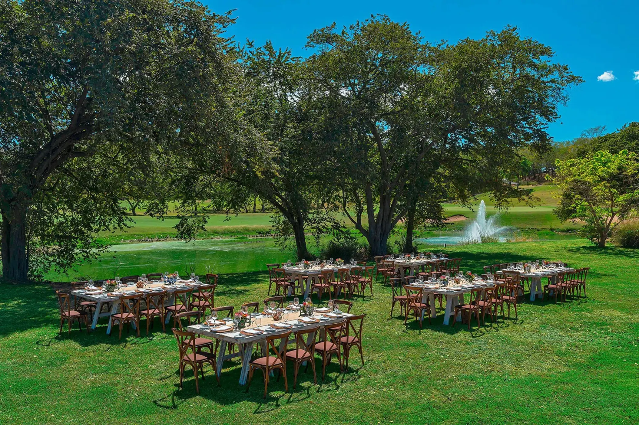 Garden wedding reception under shade trees at The Westin Reserva Conchal, Liberia