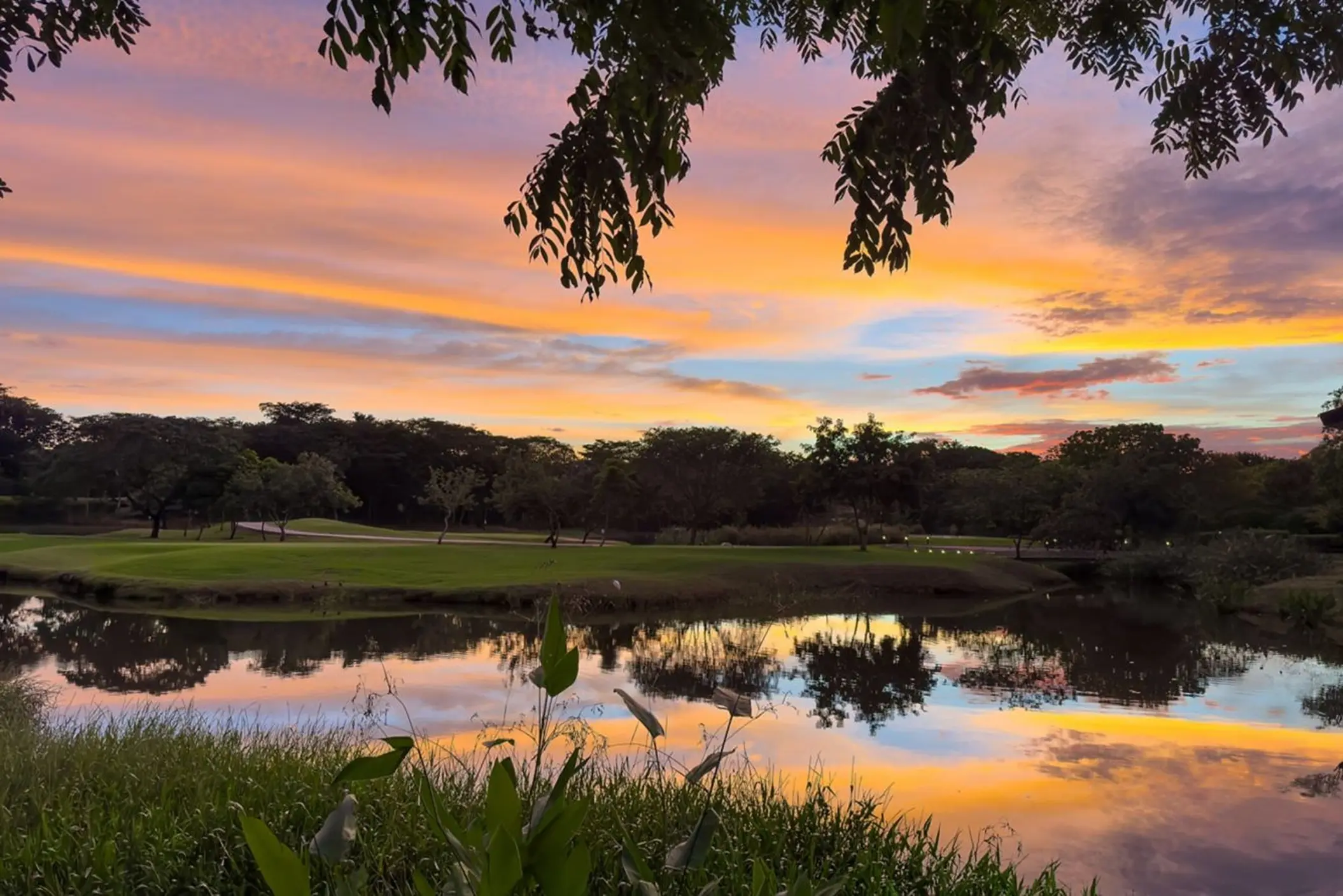 Sunset sky reflected in a pond on the golf course at The Westin Reserva Conchal, Liberia