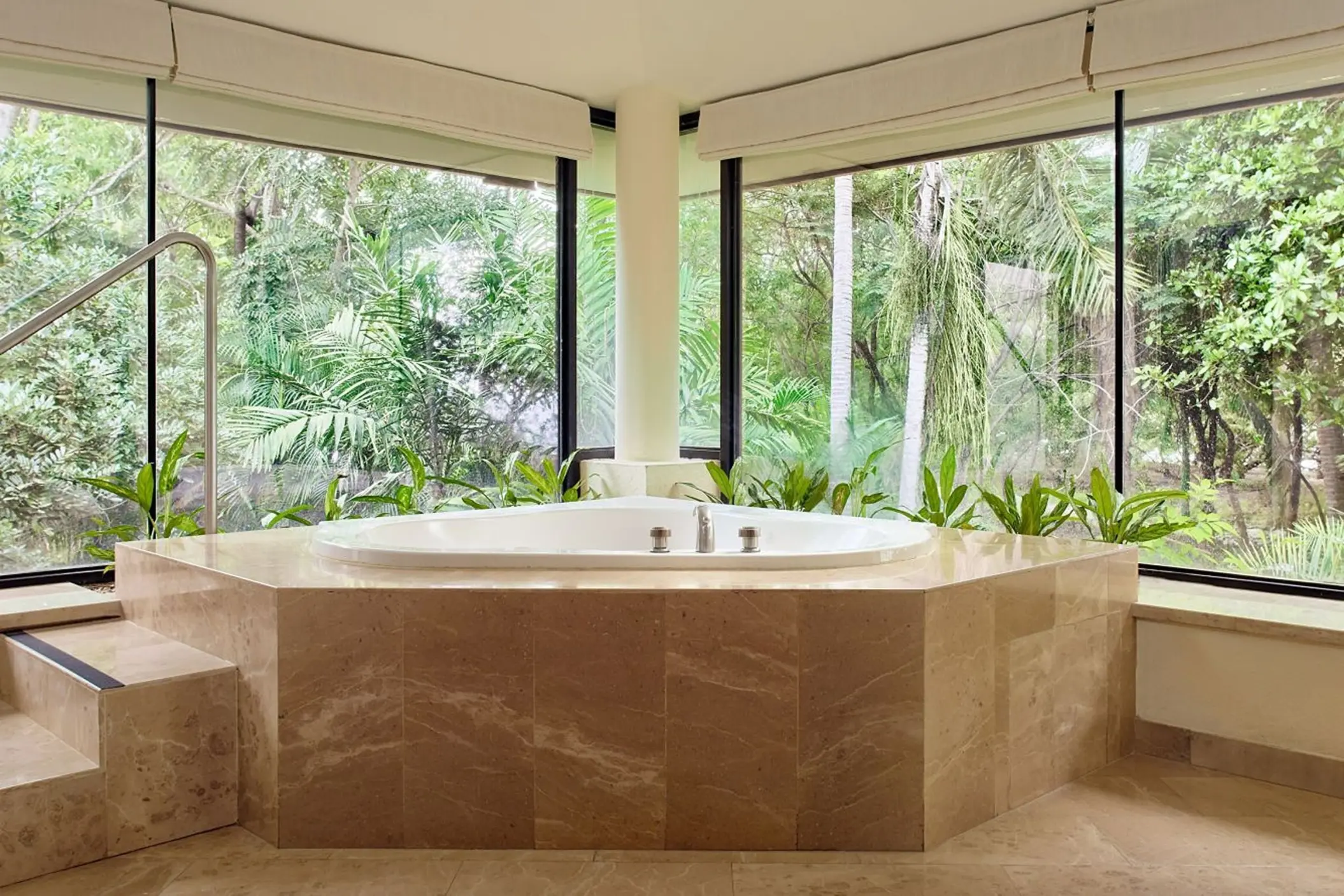 In-suite jacuzzi tub surrounded by floor-to-ceiling windows at Westin Reserva Conchal, Liberia