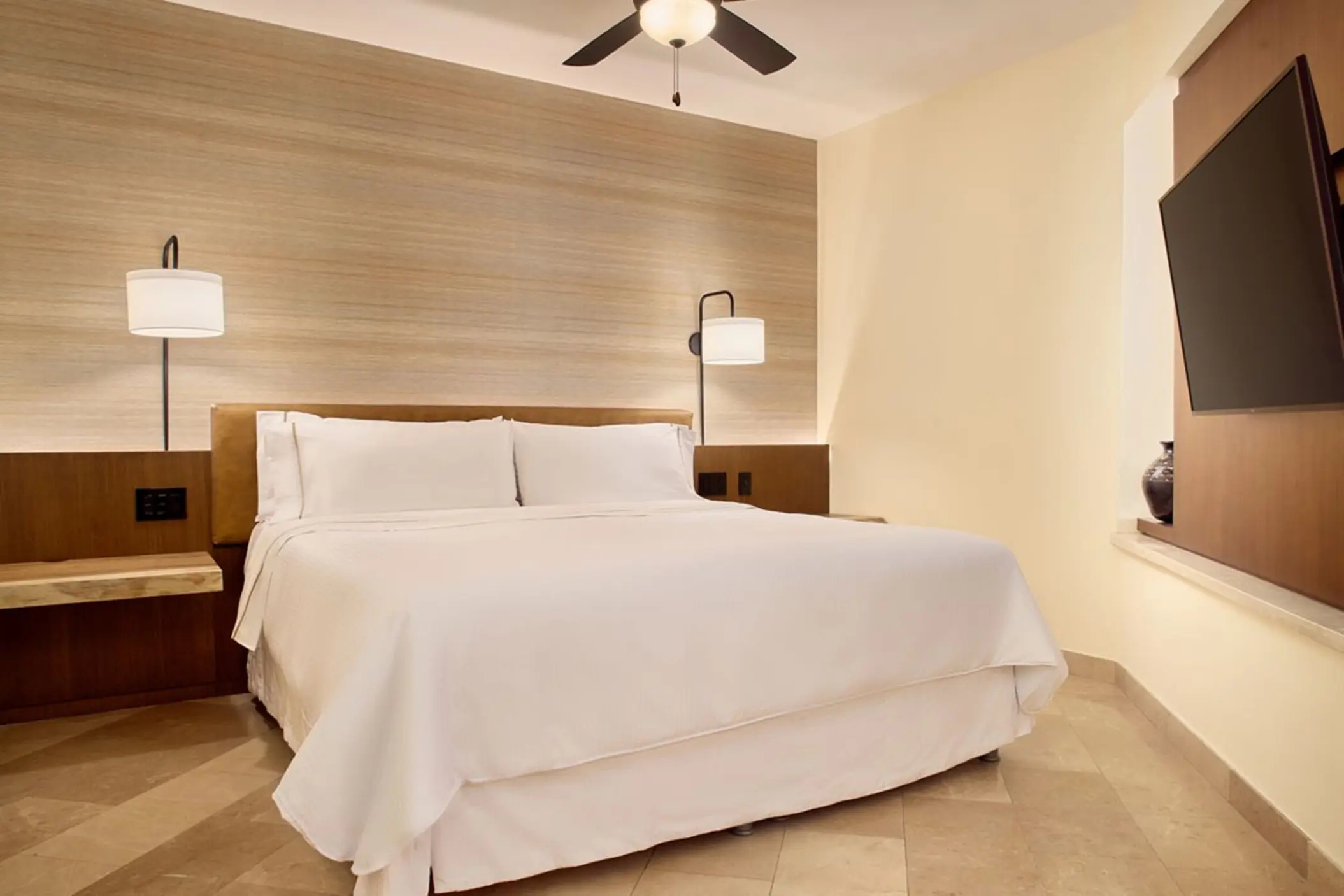 Junior Suite bedroom with white linens and wooden accents at Westin Reserva Conchal, Liberia
