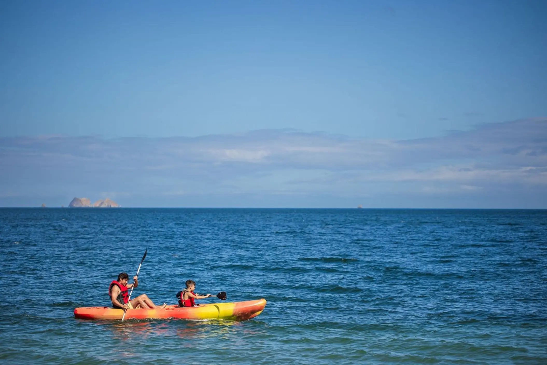 Two people kayaking on the ocean at Westin Reserva Conchal, Liberia