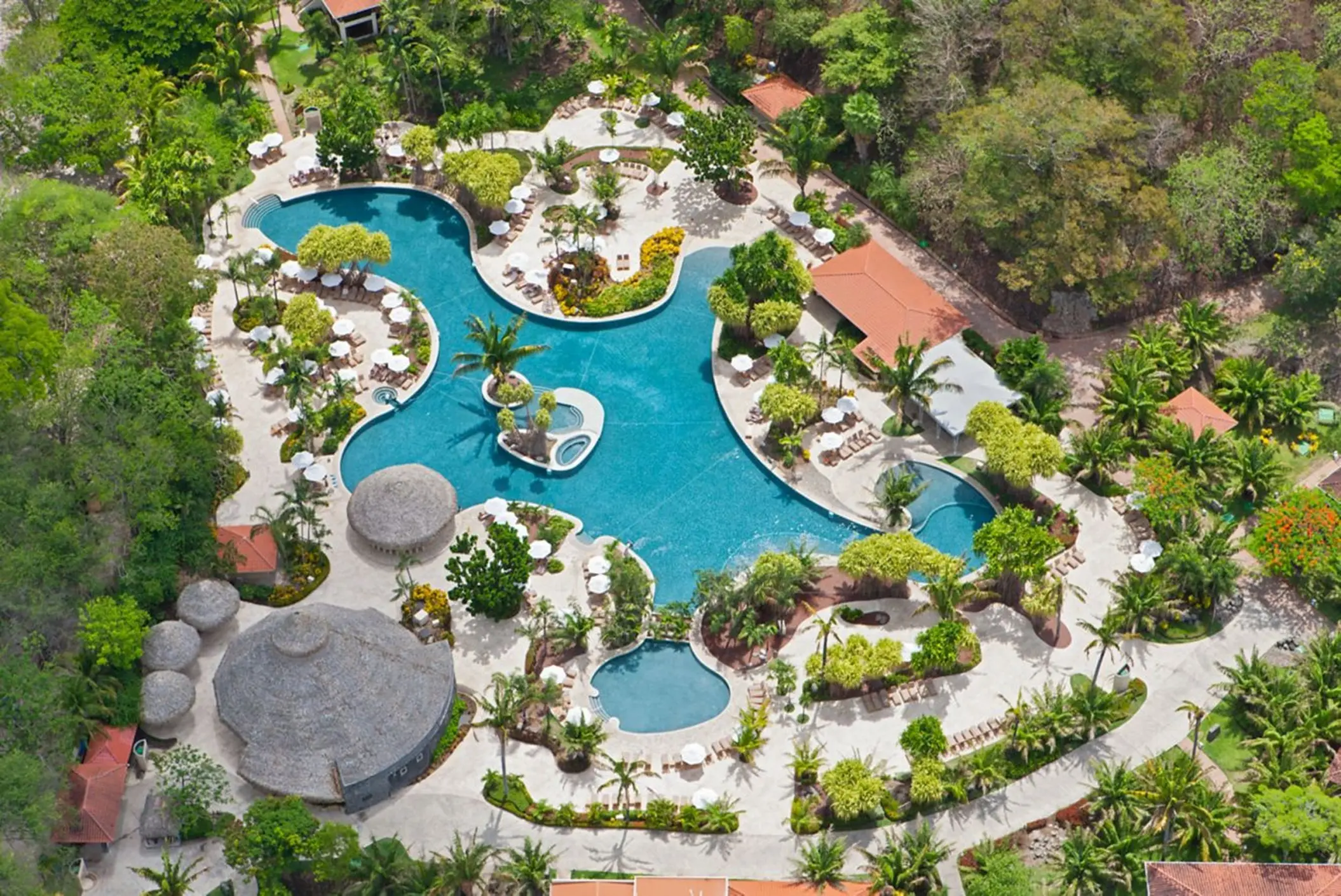 Aerial view of the lagoon-style pool surrounded by tropical gardens at Westin Reserva Conchal, Liberia