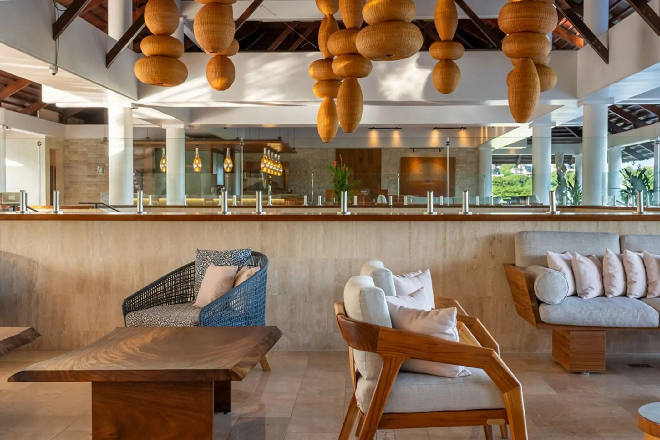 Open-air lobby lounge with modern wooden seating at Westin Reserva Conchal, Liberia