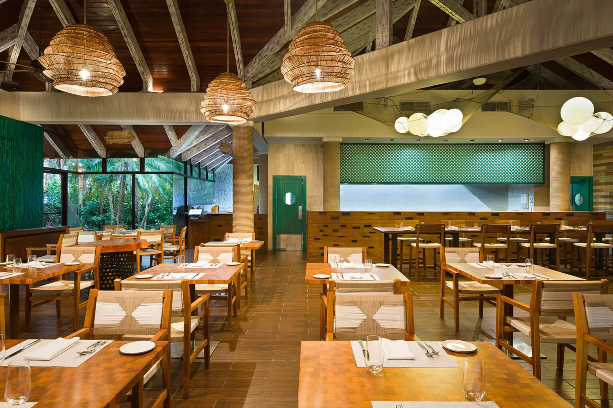 Manglar restaurant interior with wooden tables and woven pendant lights at Westin Reserva Conchal, Liberia