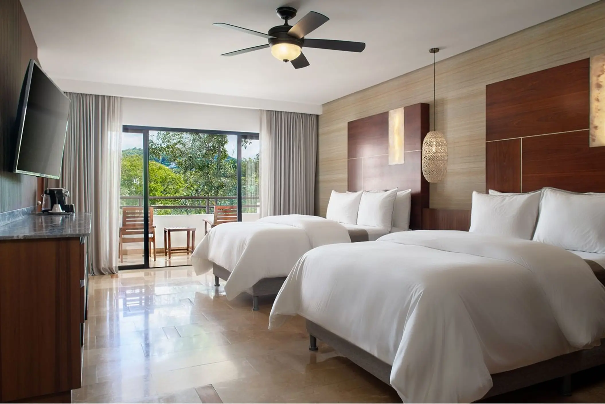 Guest suite with two beds and private balcony at Westin Reserva Conchal, Liberia