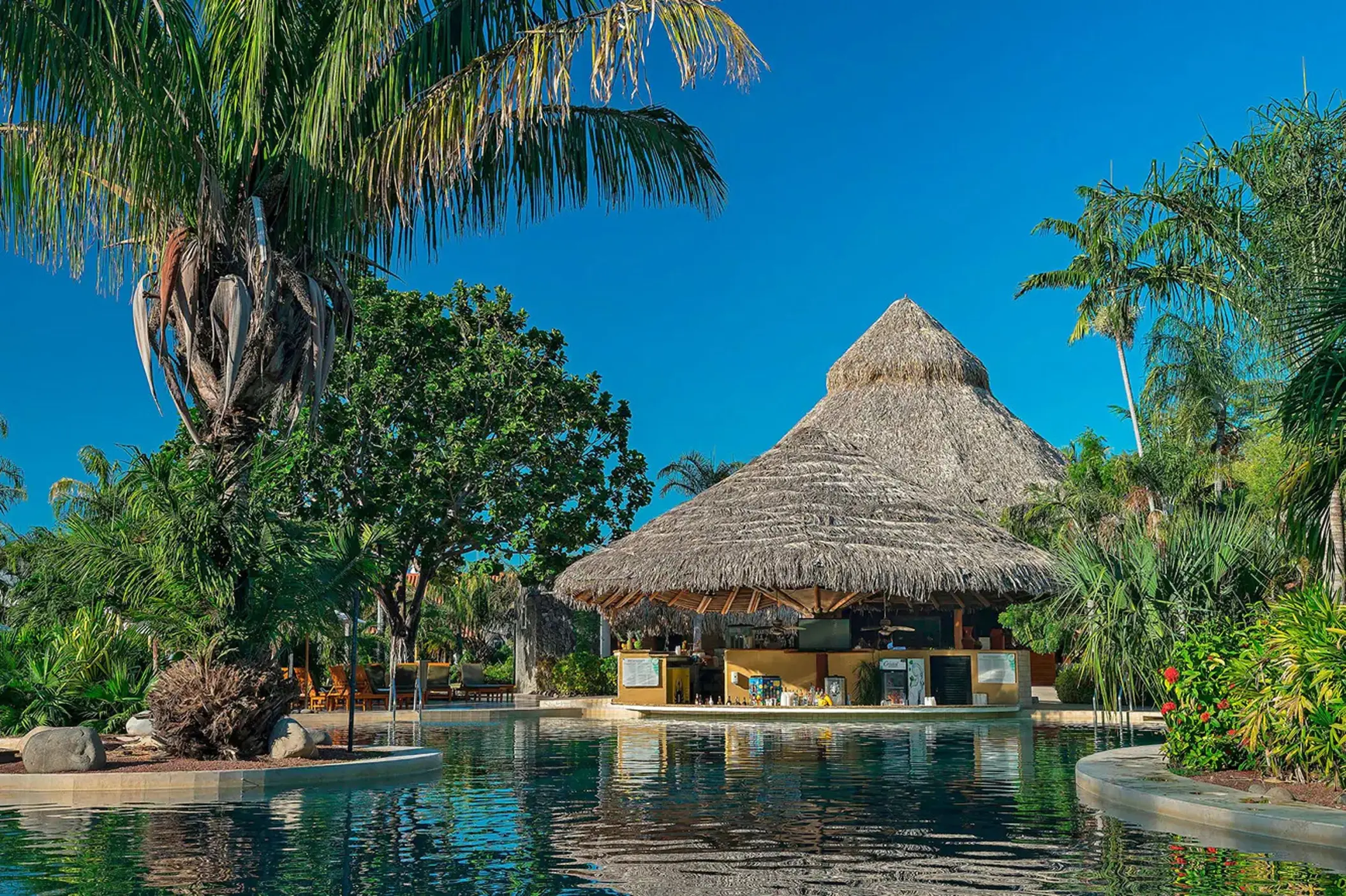 The Triton swim-up bar under a thatched roof at The Westin Reserva Conchal, Liberia