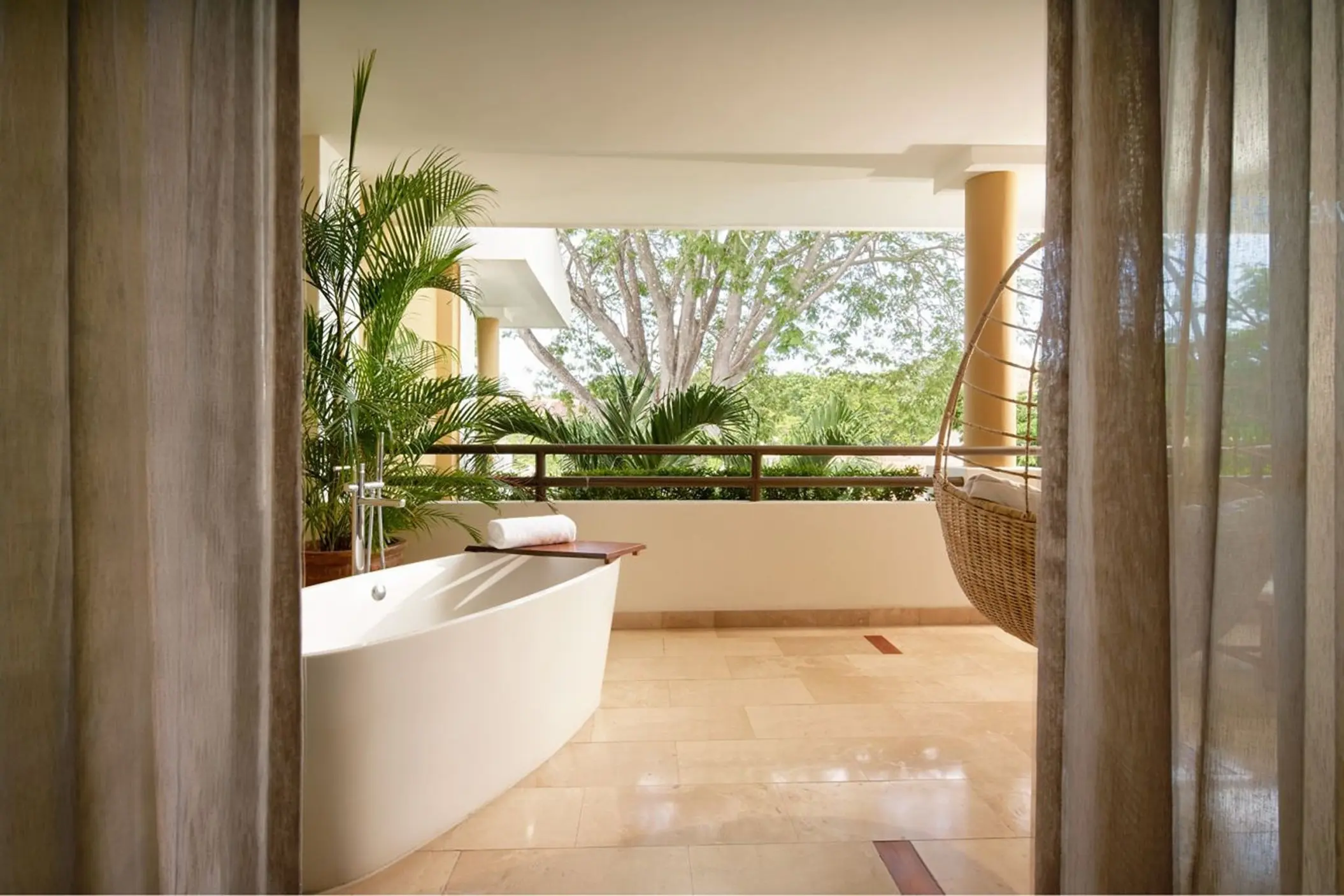 Soaking tub and hanging chair on a private suite balcony at Westin Reserva Conchal, Liberia