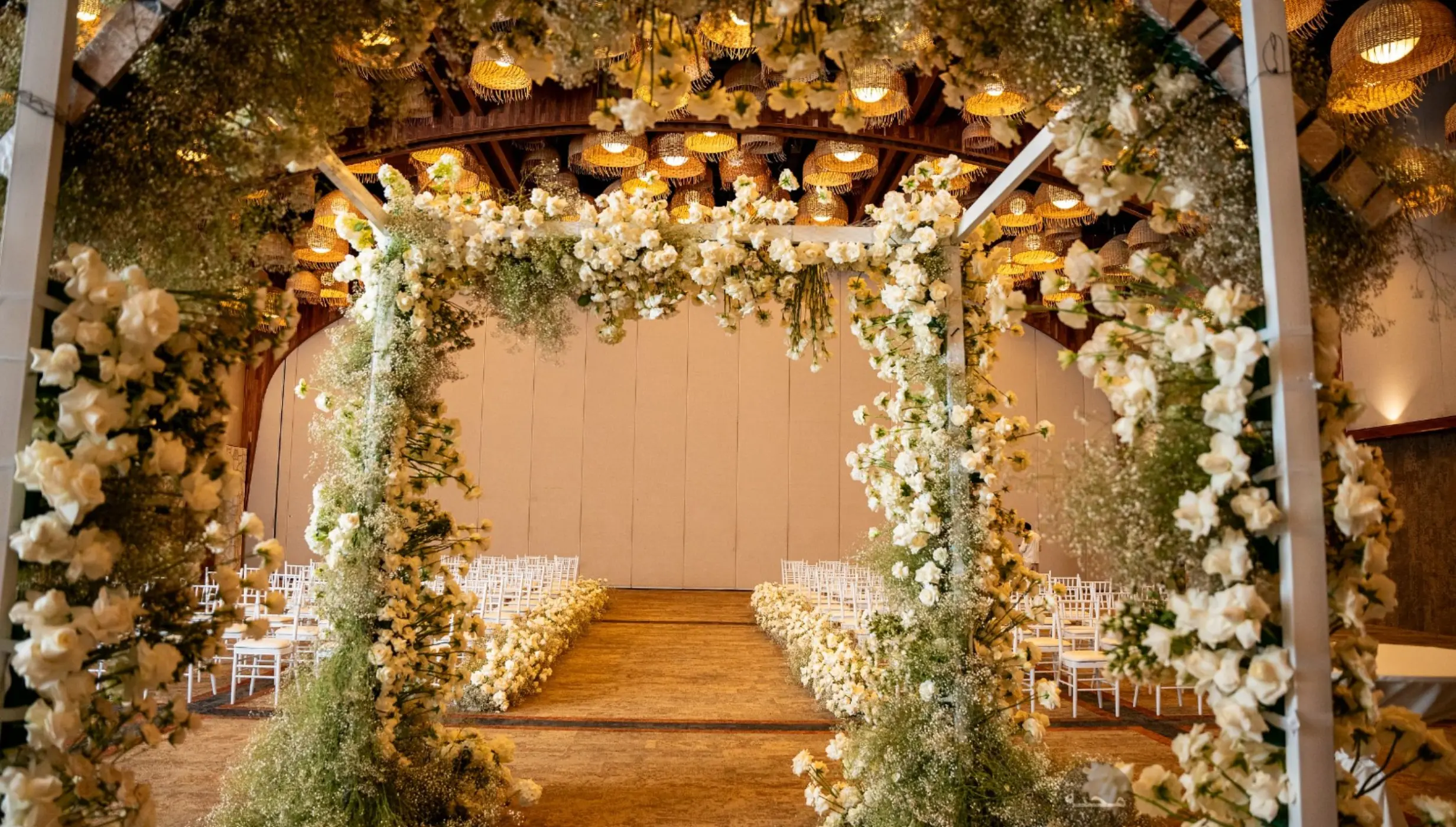 Floral wedding ceremony setup in the Diego ballroom at Hotel Xcaret Arte, Riviera Maya