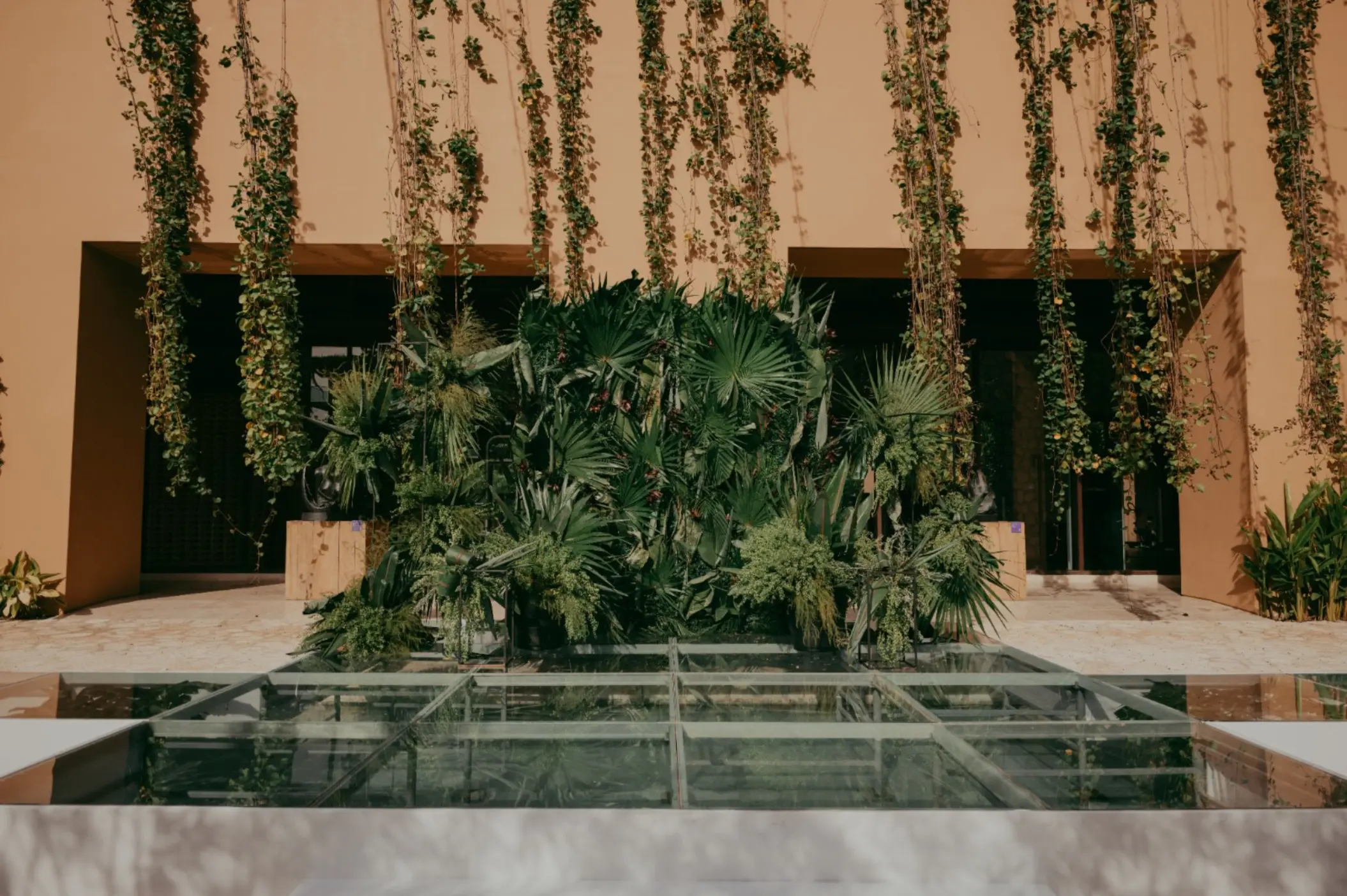 Glass walkway and tropical greenery at the Espejo de Agua venue at Hotel Xcaret Arte, Riviera Maya