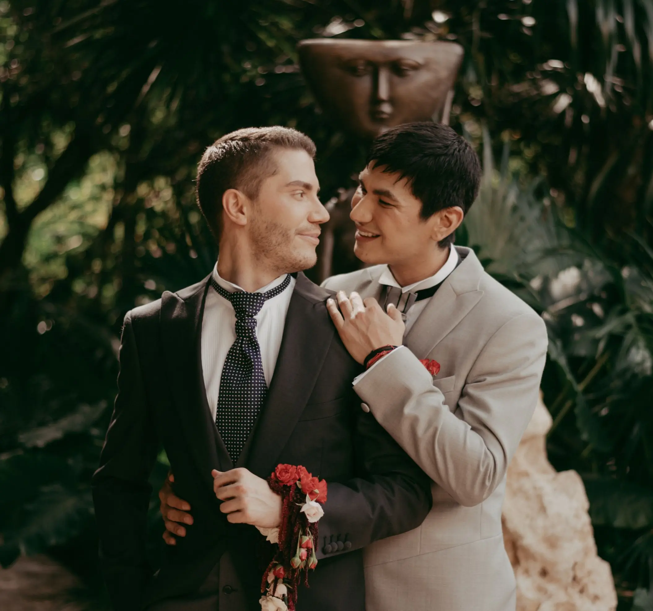 Grooms embracing during a wedding portrait at Hotel Xcaret Arte, Riviera Maya