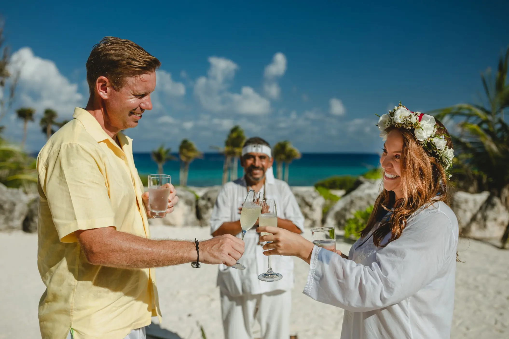 Couple toasting with drinks during a Maya ceremony at Hotel Xcaret Arte, Riviera Maya